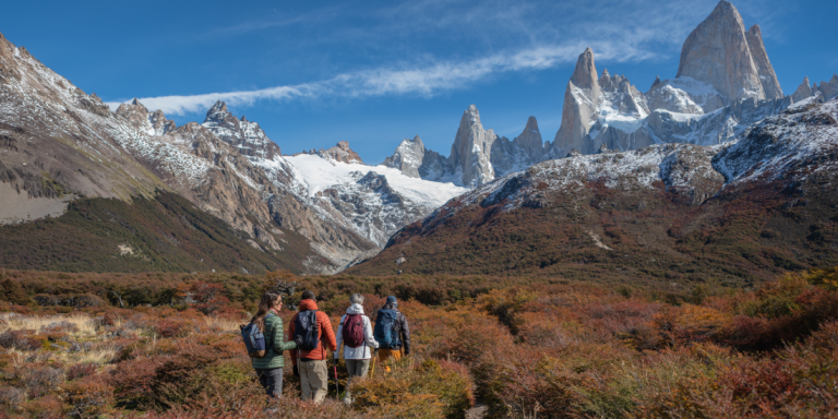 Hikers exploring the stunning Patagonian landscape with snow-capped mountains.
