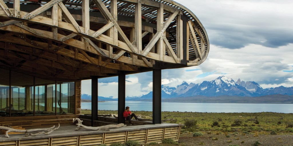 Tierra Patagonia Hotel & Spa in Torres del Paine National Park, Chile, with a panoramic view of the mountains and lake.