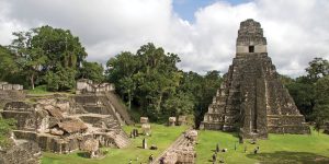 Panoramic view of the Gran Plaza in Tikal, featuring the impressive Temple I and surrounding structures.