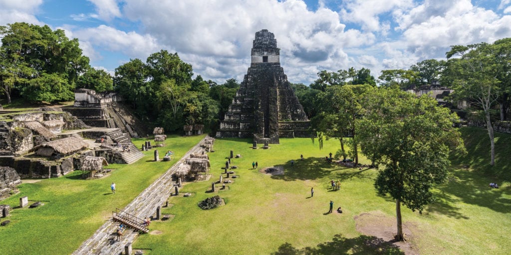Panoramic view of the Gran Plaza in Tikal, featuring the impressive Temple I and surrounding structures.