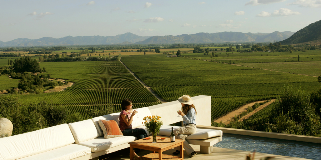 A scenic image of a two women on a terrace through a picturesque vineyard.