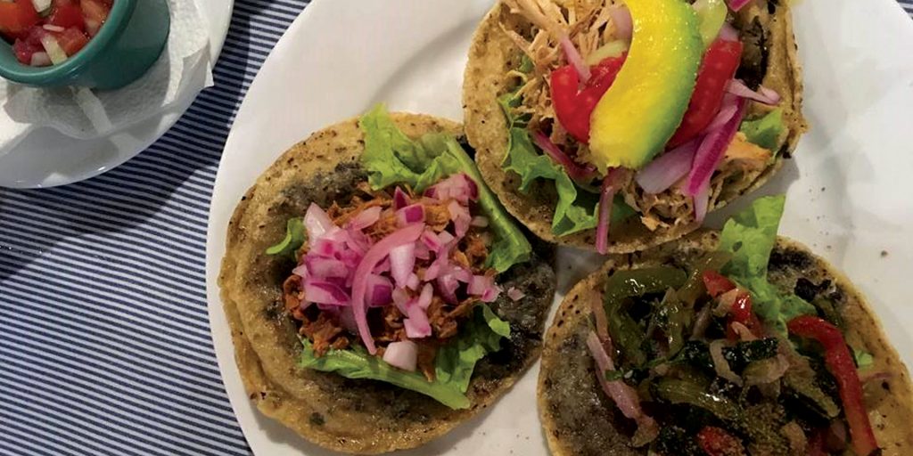 Yucatecan salbutes with chicken, vegetables, and pickled onions.