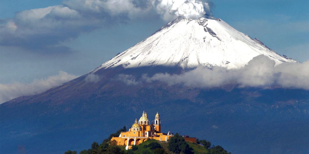 View of church and Popocatepetl Volcano in Puebla Mexico