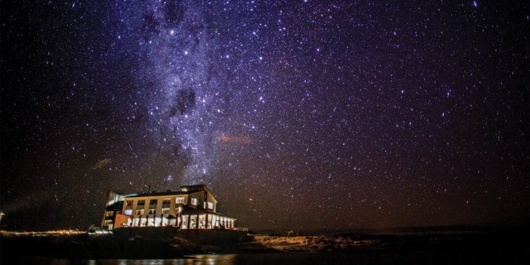 Titilaka Hotel at night, with the Milky Way visible in the sky above.