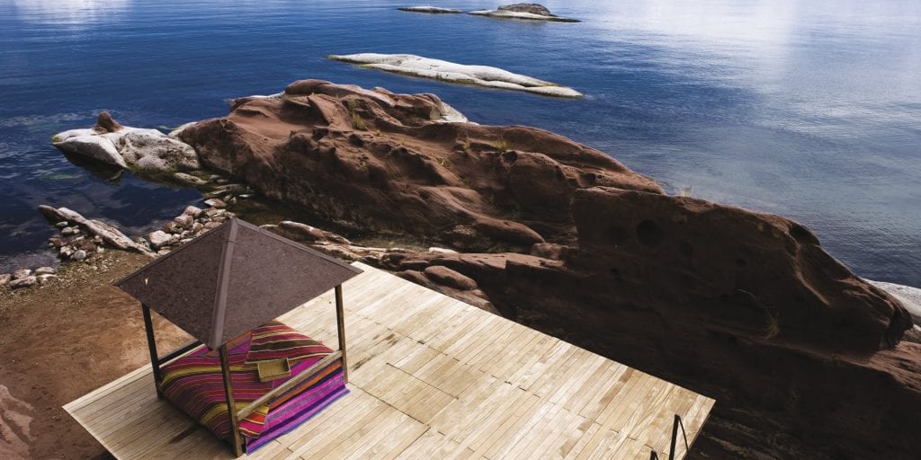 A private outdoor retreat with a wooden platform and a shaded canopy, overlooking Lake Titicaca.