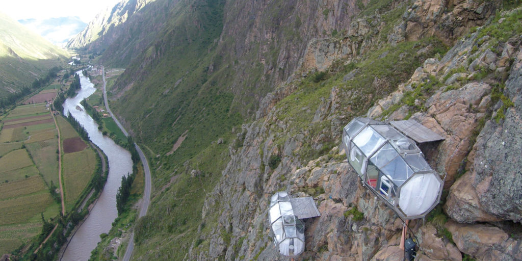 ransparent glamping capsules clinging to a cliffside in Peru's Sacred Valley.