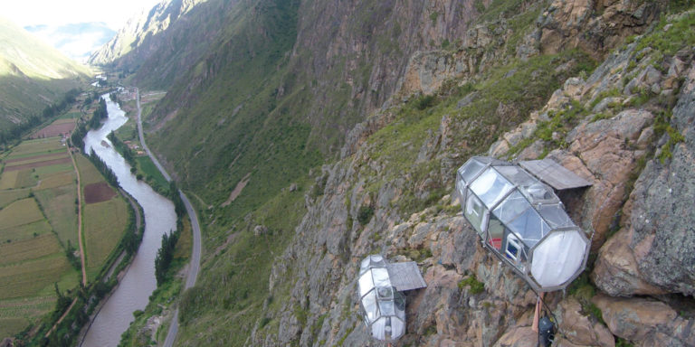 ransparent glamping capsules clinging to a cliffside in Peru's Sacred Valley.
