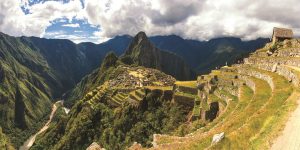 A panoramic view of Machu Picchu, with its ancient stone structures nestled in the Andes Mountains