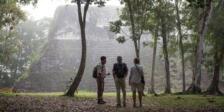 Tourists and guide in Uaxactun Guatemala