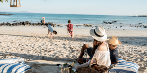 A family enjoying a picnic on a beautiful Galapagos beach.