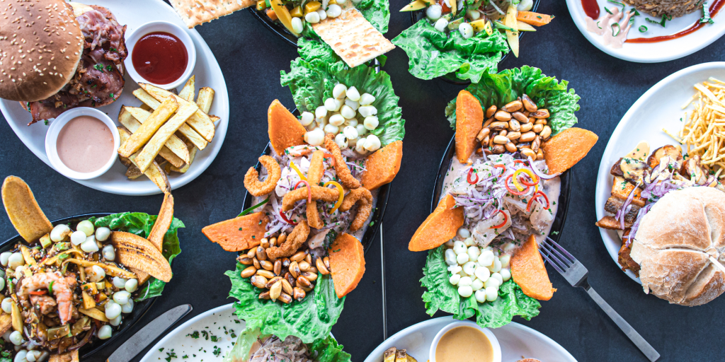 A colourful and diverse spread of Peruvian dishes, including ceviche, lomo saltado, anticuchos, and more.