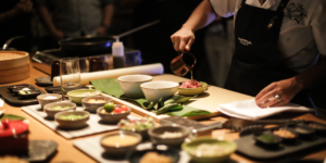 Close-up of hands preparing Peruvian food in a cooking class setting in Lima.