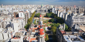 Aerial view of the dense urban sprawl of Buenos Aires with distinct architectural features and green spaces.