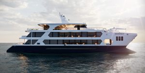 The image showcases the Hermes Mega Catamaran, a sleek and modern vessel with a predominantly white hull and a navy blue base. It's positioned in open water, likely at sunset, with a warm glow illuminating the sky. The catamaran's design emphasises spaciousness and comfort, with multiple decks and large windows.