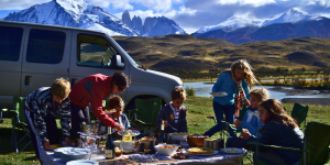 Group of people enjoying a picnic amidst a vast Patagonian landscape.