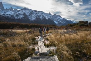 Hikers exploring the stunning Patagonian landscape with snow-capped mountains.