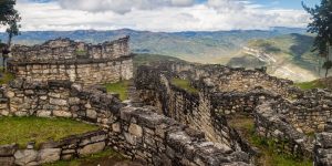A scenic landscape with mountains and ancient ruins.