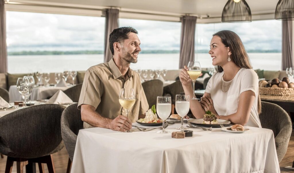 MV Zafiro dining room with guests on the Amazon River