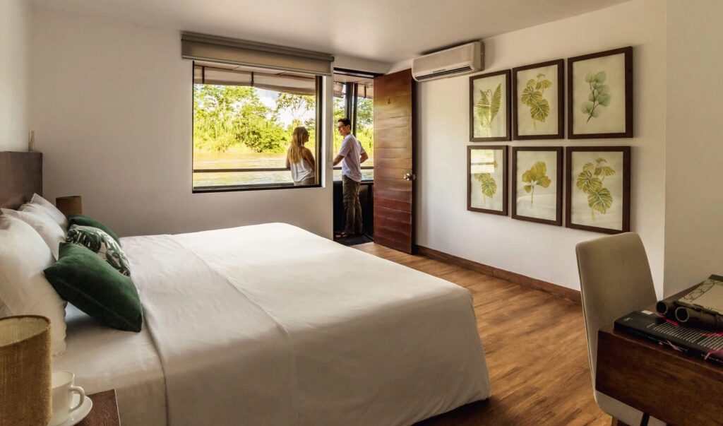 MV La Perla ship cabin with guests on the Amazon River